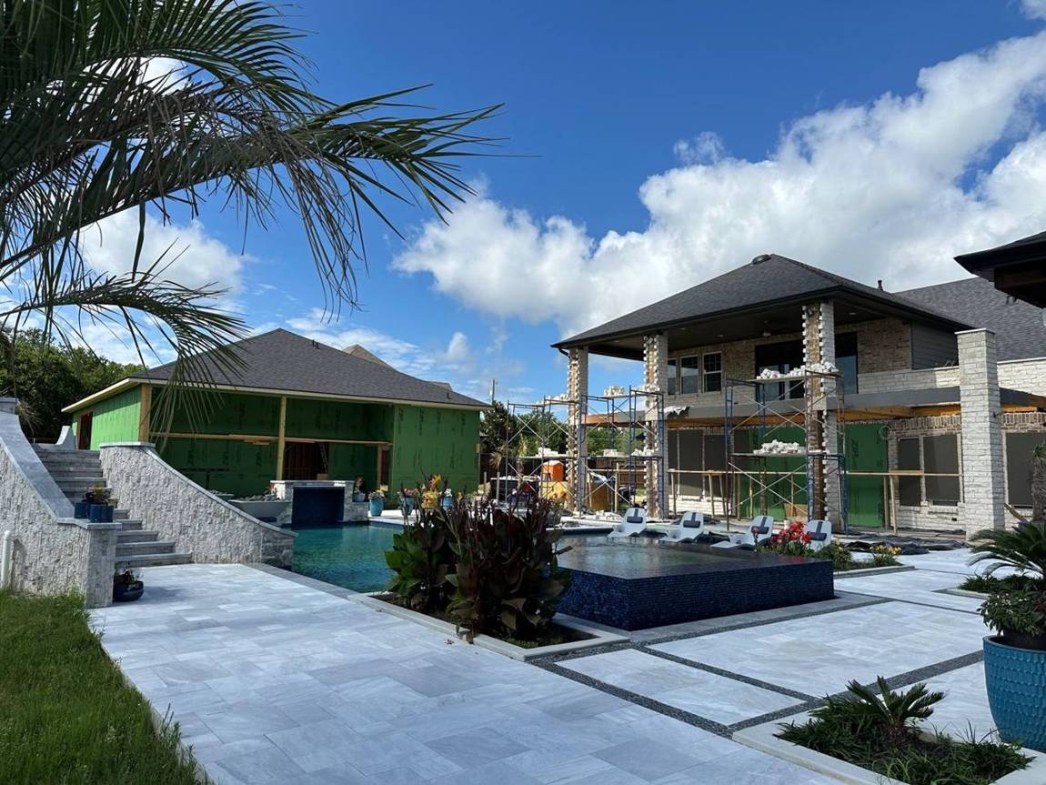 The warehouse in ZIP System next to the pool and the main house under scaffolding
