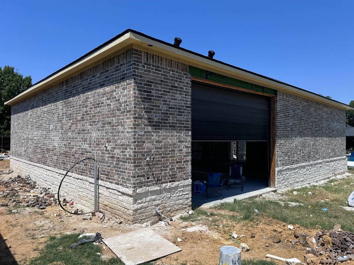 Brick and stone warehouse with a black roll-up door
