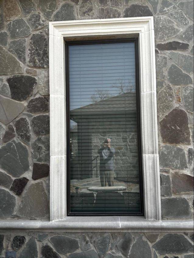 Finished window with cast stone surround and sill