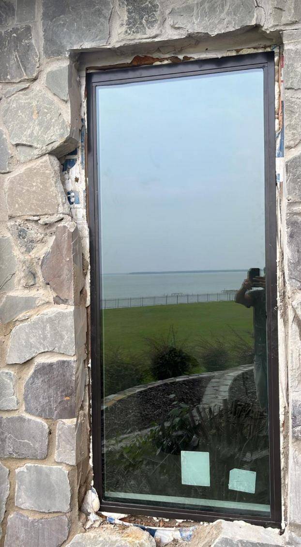 New window set into the stone wall before trim